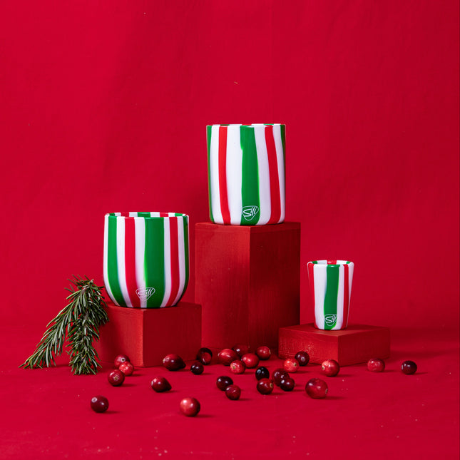 Decorative vases with red, green, and white striped pattern on a red background