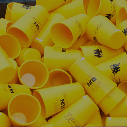 Image of a box full of yellow Silipint Cups Customized for a promotional event.